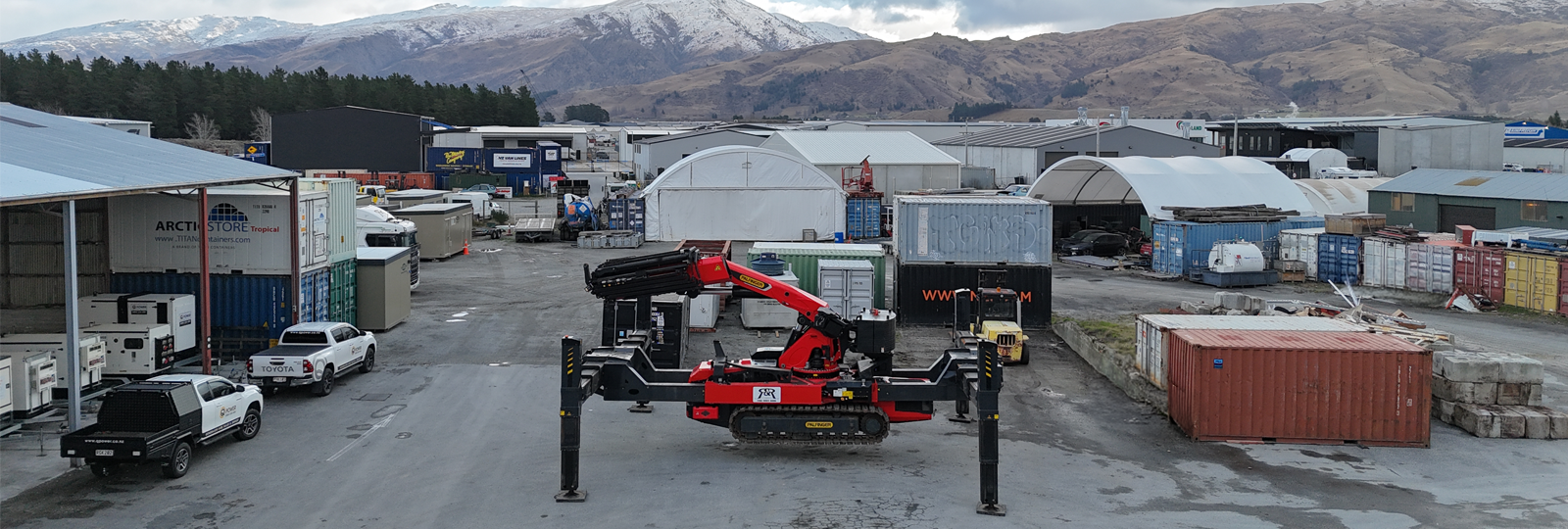 PALFINGER PCC115 crawler crane set up with outriggers in R&R's yard, with Central Otago mountains in the background